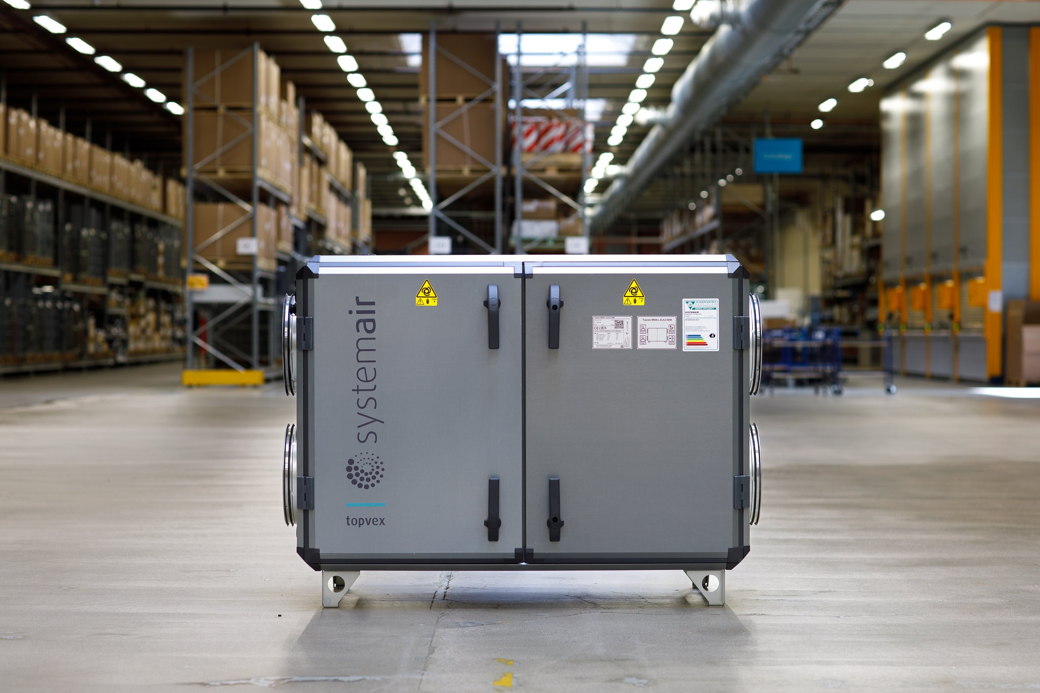 A large industrial air handling unit by Systemair, branded 'Haviva', shown in a warehouse setting on a concrete floor.